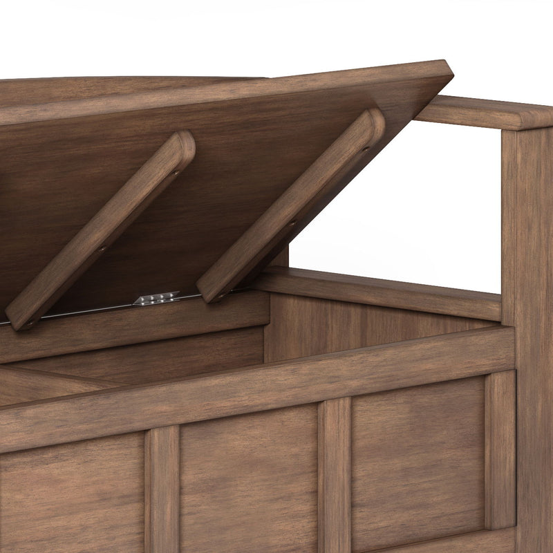 Lift-top storage bench showing underside and hinges; rustic brown wood panels.