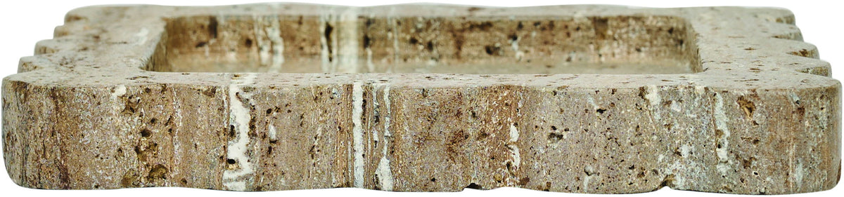 Natalie travertine tray edge view; speckled stone with scalloped sides and layered cut.