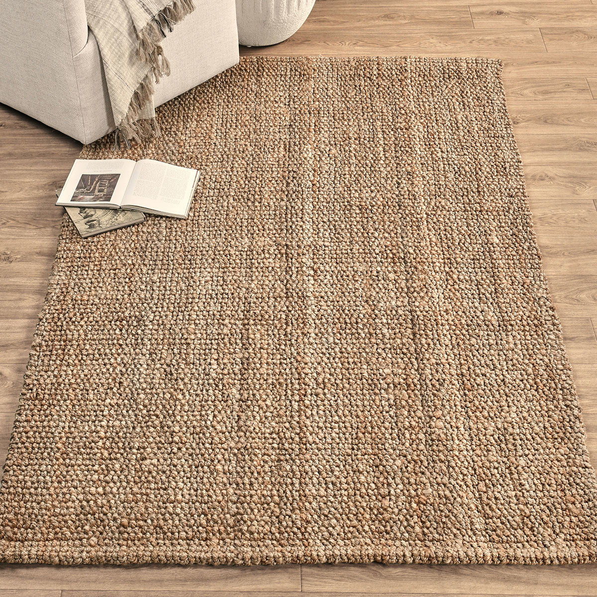 Beige chunky loop rug with dense loop pile, shown laid on hardwood flooring