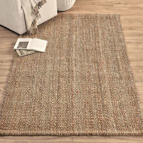 Beige chunky loop rug with dense loop pile, shown laid on hardwood flooring