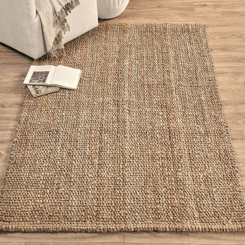Beige chunky loop rug with dense loop pile, shown laid on hardwood flooring