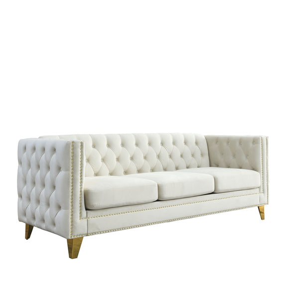 White button-tufted upholstered sofa with studded trim and gold-toned legs