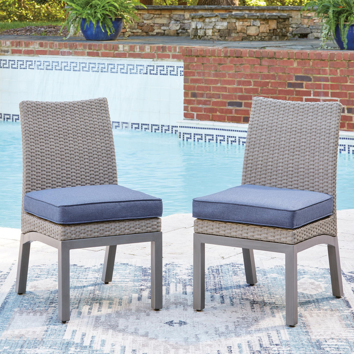 Set of 2 gray woven side chairs with blue cushions and gray legs