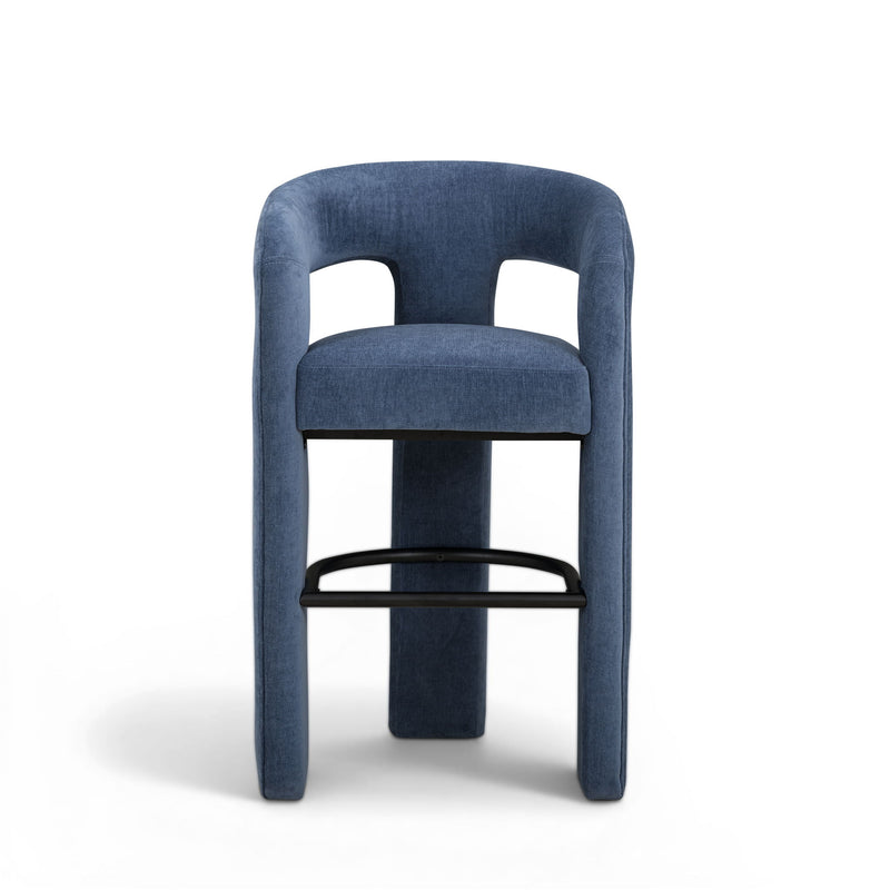 Blue upholstered stool front view with rounded backrest and black footrest