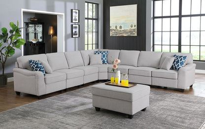 Gray modular sectional sofa with ottoman, corner chaise and blue patterned throw pillows