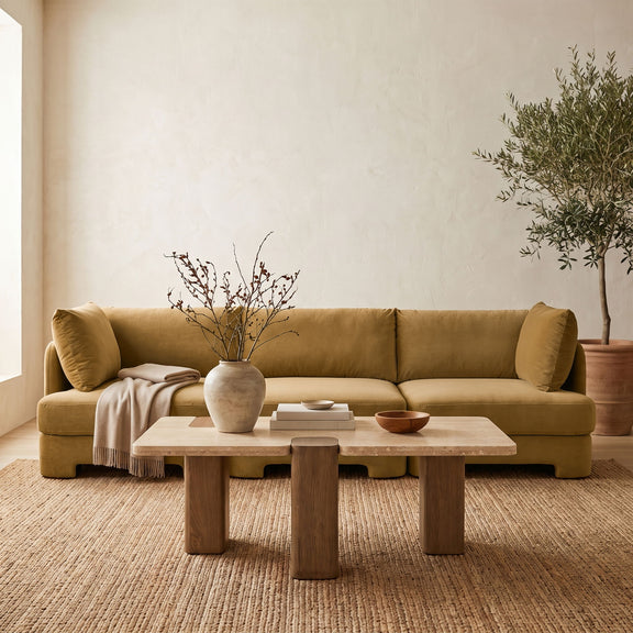 Light brown velvet 3-piece sofa with three seat cushions and rounded arm bolsters