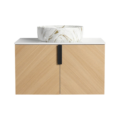 Wall-mounted bathroom vanity with light wood cabinet, white countertop, and art sink