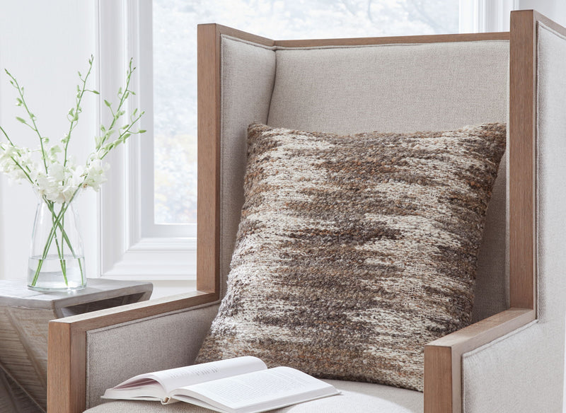 Brown-and-white textured square throw pillow on upholstered seating