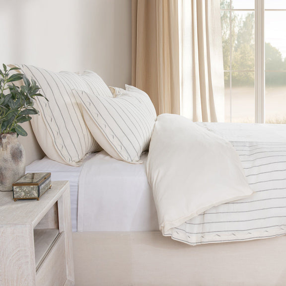 White duvet cover with thin stripe pattern and folded corners