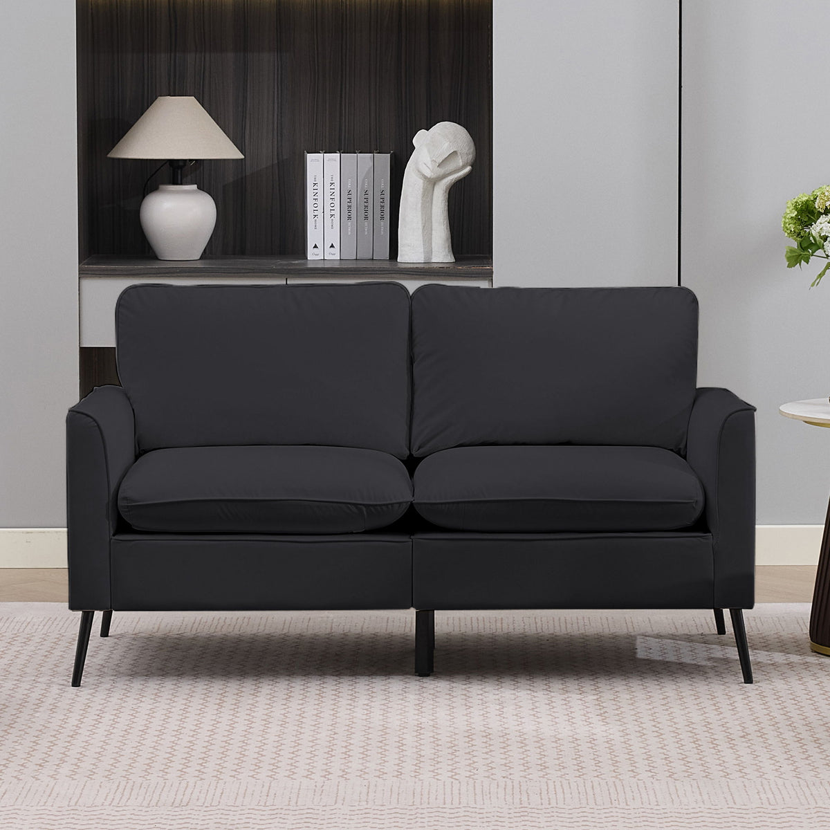 Black 2-seat upholstered loveseat with squared cushions, padded arms, and slim metal legs