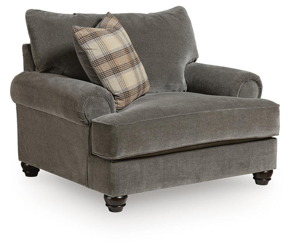 Shadow gray chair and a half with rolled arms and plaid accent pillow