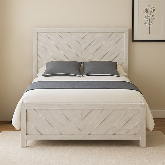 Modern bed with light gray panel headboard, white duvet, and two gray throw pillows