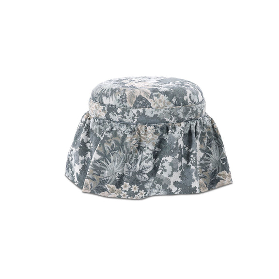 Round storage ottoman with blue-gray floral tapestry fabric and gathered skirt
