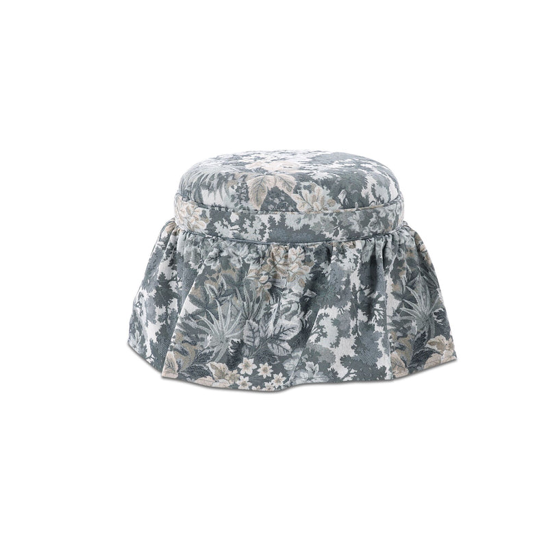 Round storage ottoman with blue-gray floral tapestry fabric and gathered skirt