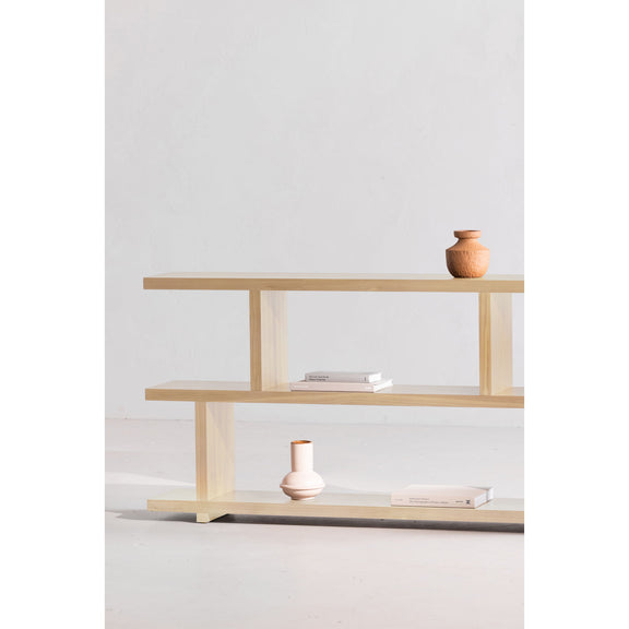 White-wash oak small shelf unit with two visible tiers and open side frame