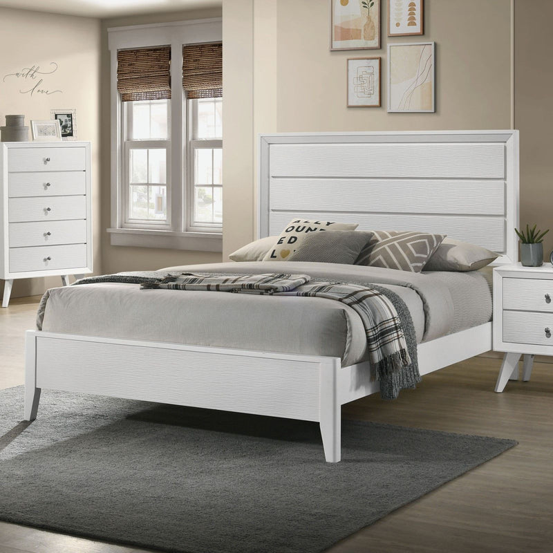 White upholstered bed with paneled headboard, slatted base, and angled legs