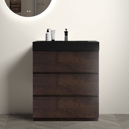 Freestanding bathroom vanity with dark wood drawers and black countertop with chrome faucet