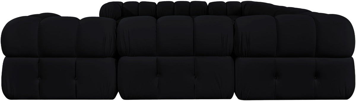 Black velvet sectional with tufted cushions, rounded arms, and blocky seat sections