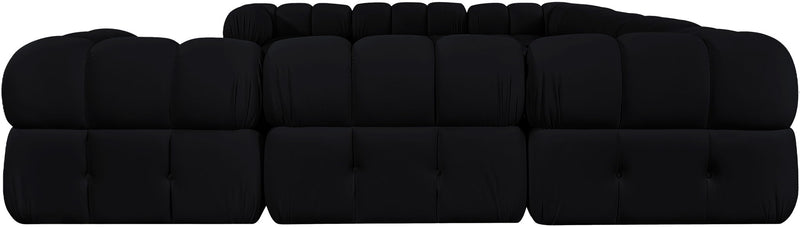 Black velvet sectional with tufted cushions, rounded arms, and blocky seat sections