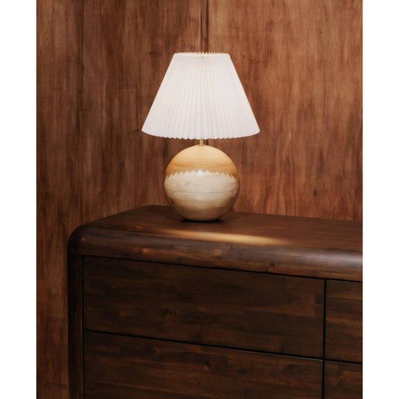 Dark brown dresser with curved top rail and lamp on the upper surface