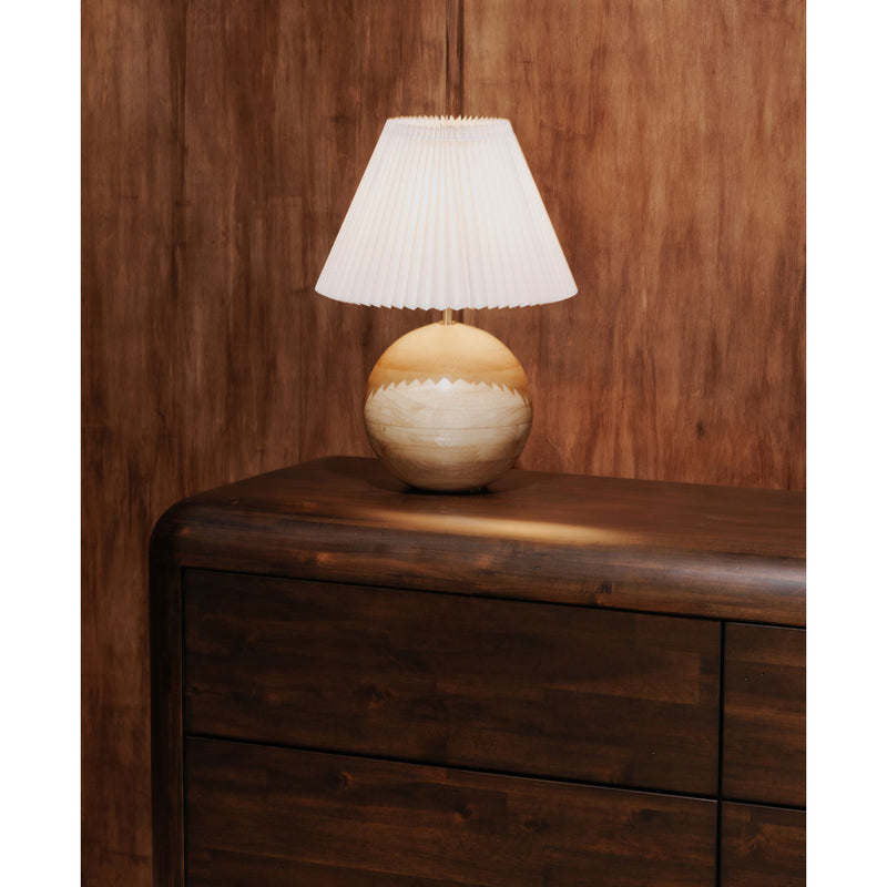Dark brown dresser with curved top rail and lamp on the upper surface