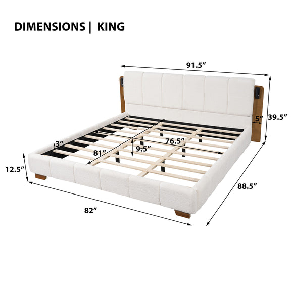 White upholstered king platform bed with slats, side reading lights, and tall headboard