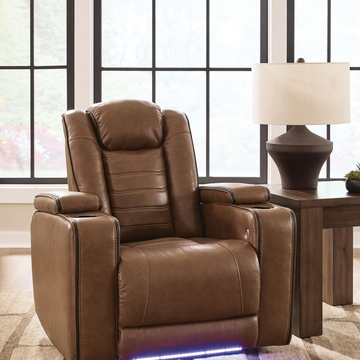 Amber recliner with adjustable headrest, padded seat and arms, blue LED base glow