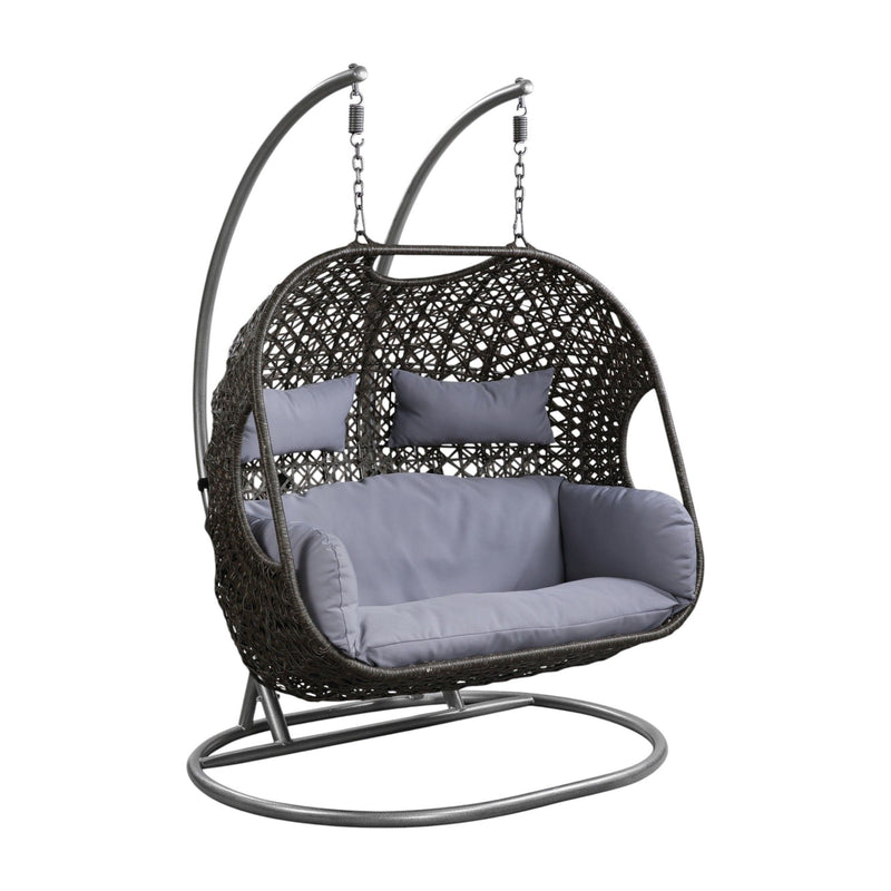 Gray hanging wicker chair with curved stand and light gray seat cushions
