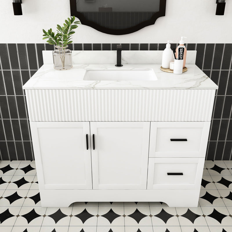 White bathroom vanity with rectangular sink, fluted front, two doors and two drawers.