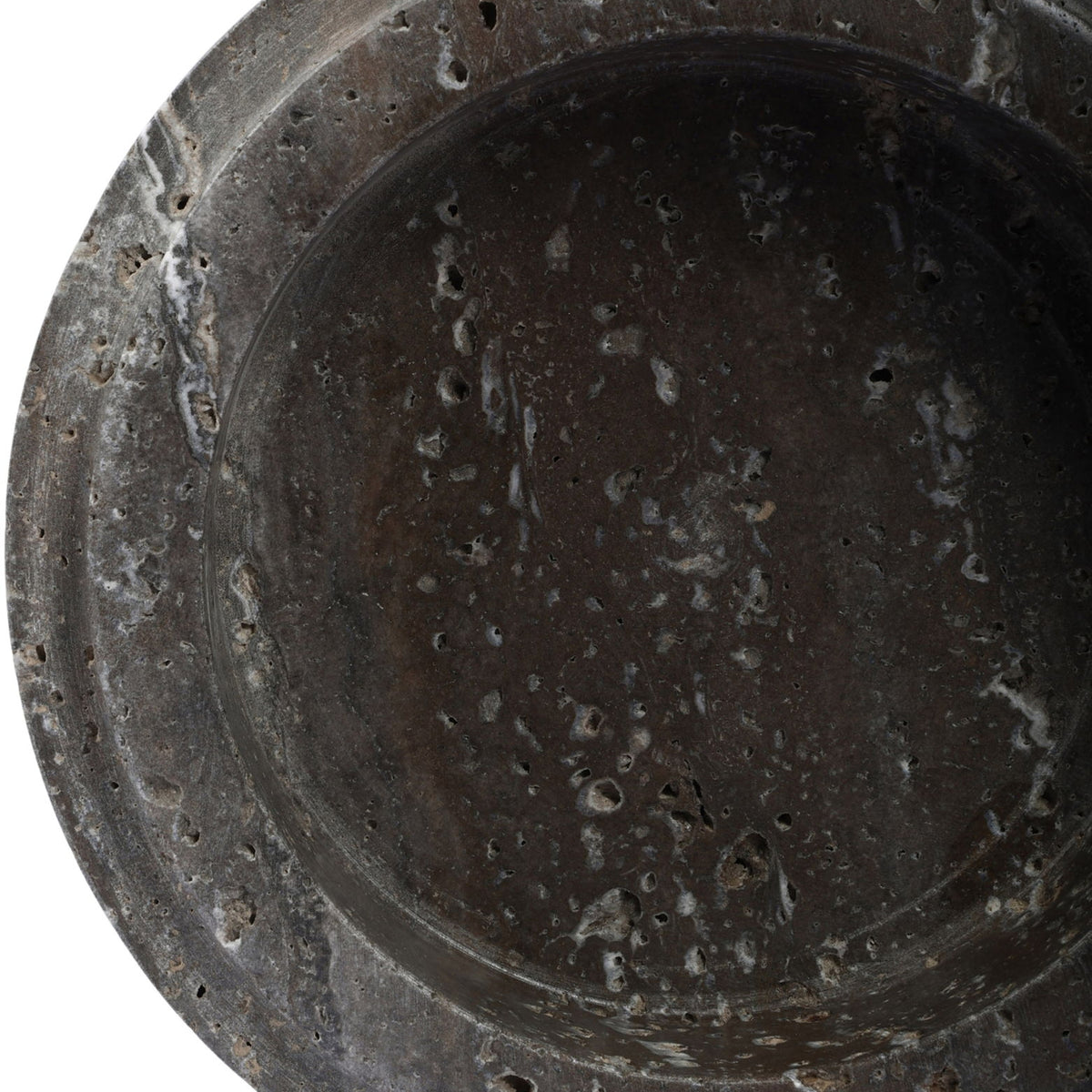 Close-up of Parsons travertine bowl interior, dark gray speckled surface and rounded rim