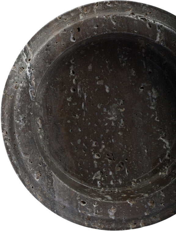 Close-up of Parsons travertine bowl interior, dark gray speckled surface and rounded rim