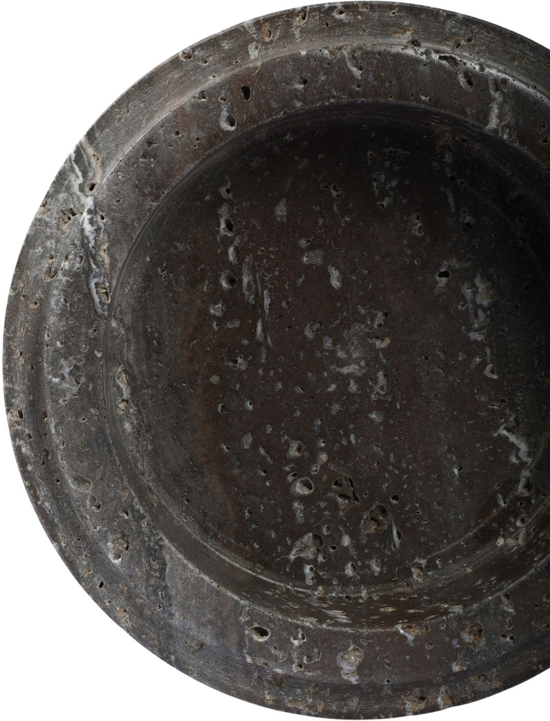 Close-up of Parsons travertine bowl interior, dark gray speckled surface and rounded rim