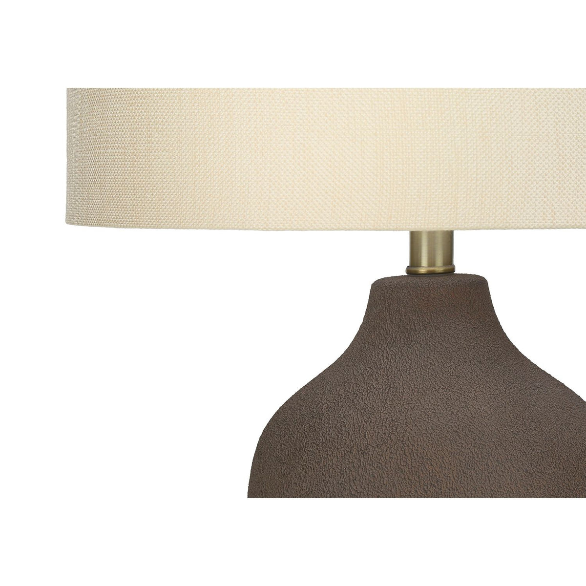 Dark gray ceramic lamp base with off-white textured drum shade and brass socket