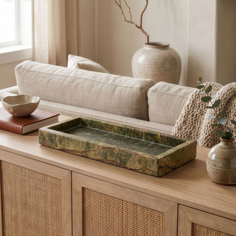 Long rectangular green marble tray with floral accents and candles on top.