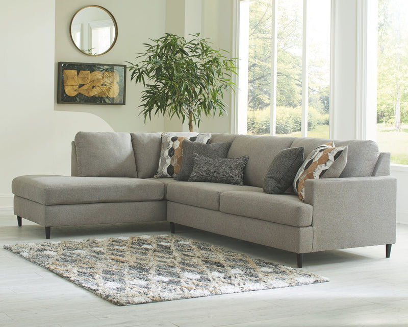 Gray L-shaped sectional sofa with chaise and stacked back cushions.