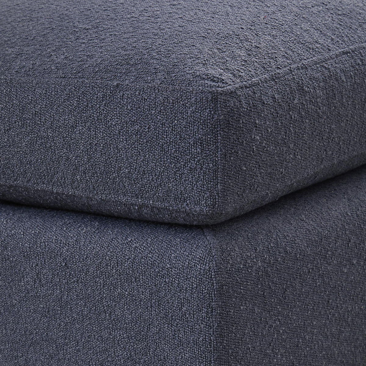 Close-up of dark textured fabric on ottoman seat and side seam