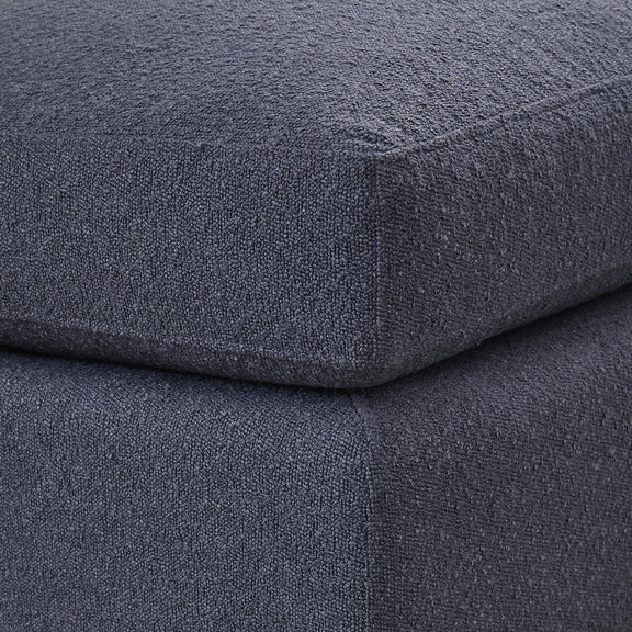 Close-up of dark textured fabric on ottoman seat and side seam