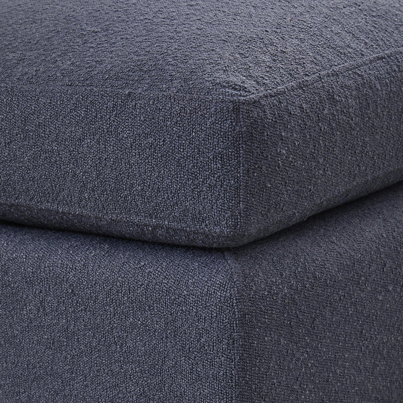 Close-up of dark textured fabric on ottoman seat and side seam