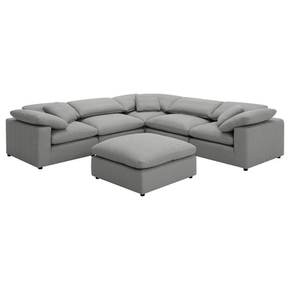 Dark gray modular sectional sofa with curved arms and matching ottoman chaise