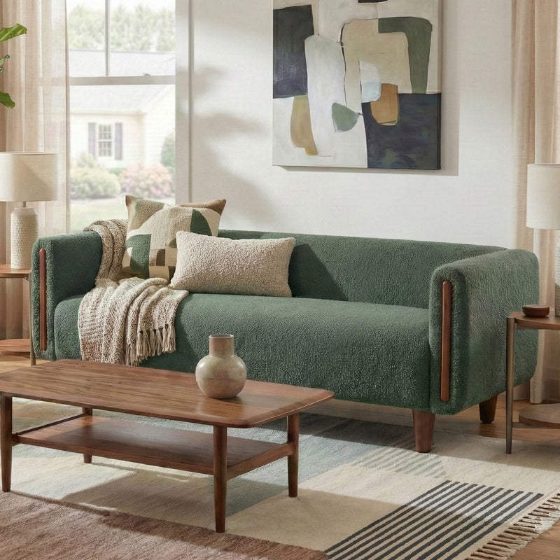 Dark green 3-seater sofa with armrests with pillows, styled in a living room