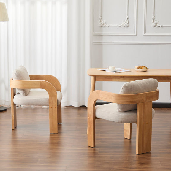 Pair of beige dining chairs viewed from behind, showing curved wood arms and padded backs