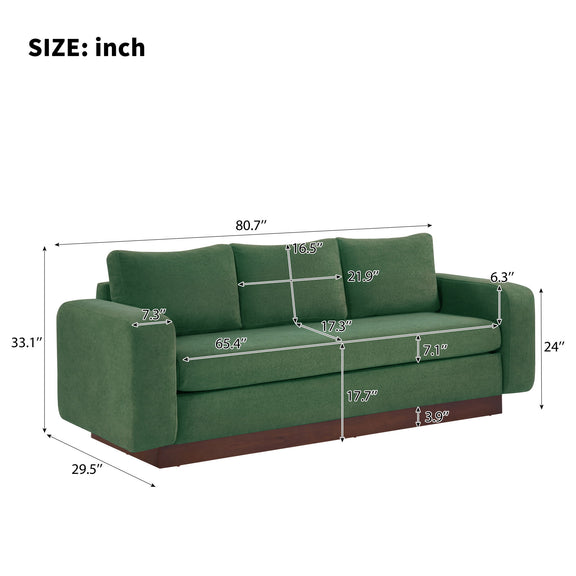 Dark green 3-seater sofa with padded rounded arms and box seat cushions
