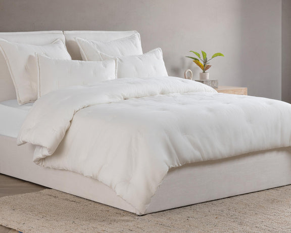 Cloud comforter sham pair on bed, solid white with clean edges