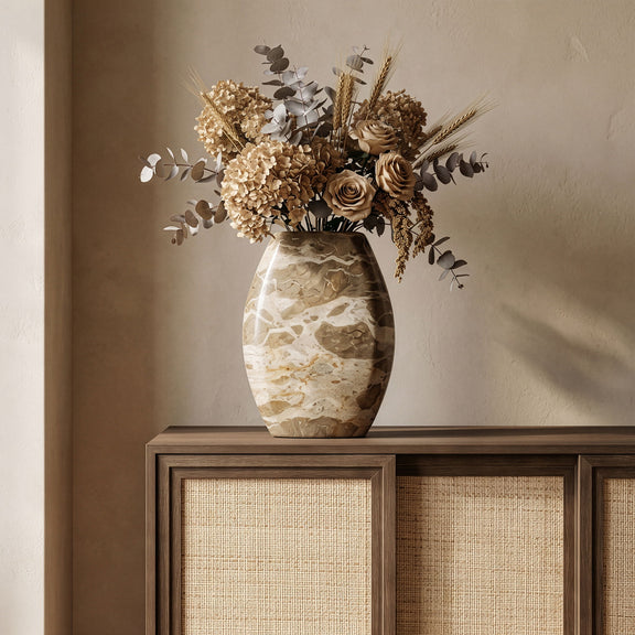 Beige marble vase with dark opening, rounded oval shape and natural stone veining.