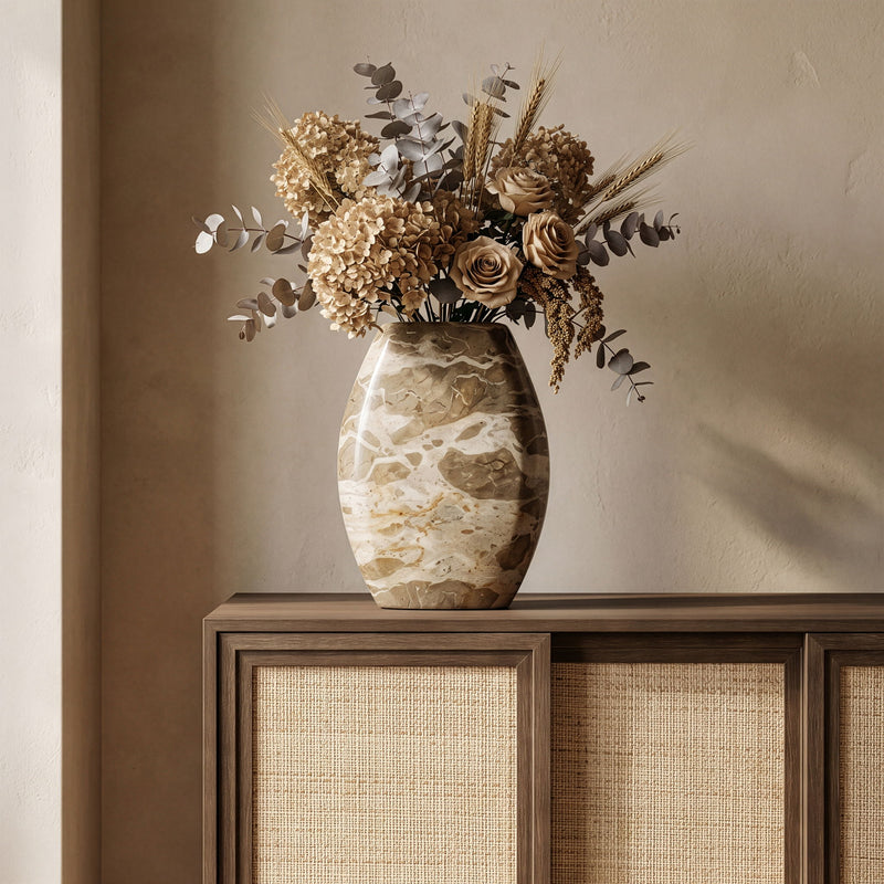 Beige marble vase with dark opening, rounded oval shape and natural stone veining.