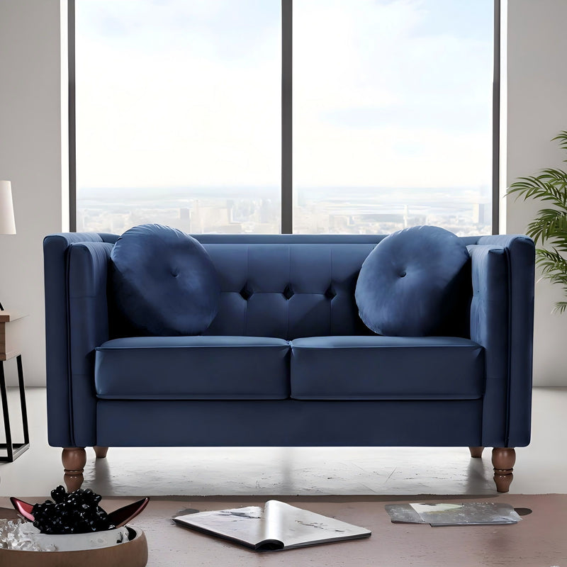Navy blue tufted 2-seater loveseat with round arm cushions and button-tufted back pillows.