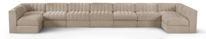 Beige velvet modular sectional sofa with tufted cushions and curved armrests