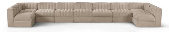 Beige velvet modular sectional sofa with tufted cushions and curved armrests