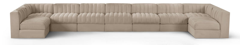 Beige velvet modular sectional sofa with tufted cushions and curved armrests
