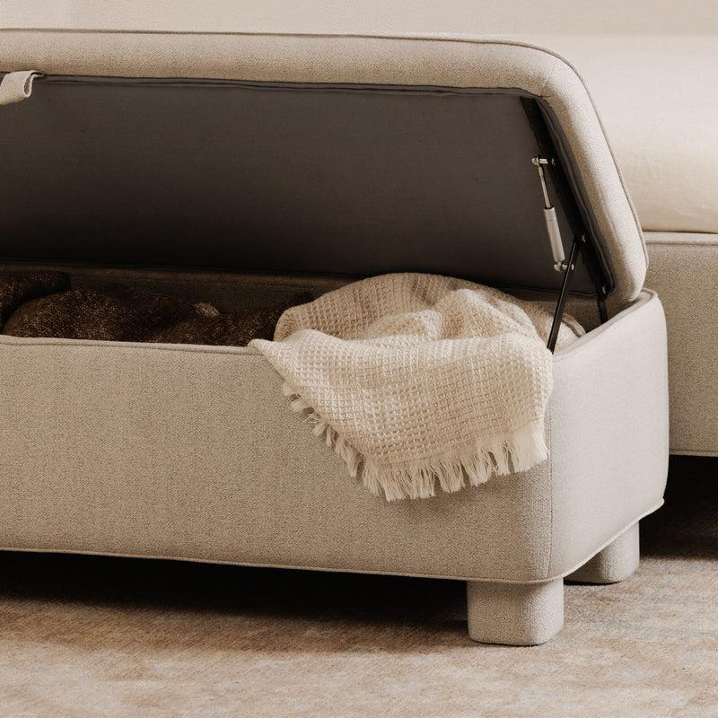 Light gray upholstered storage bench with open lid showing interior compartment